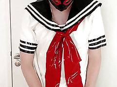 Putting on latex Japanese schoolgirl sailor uniform skirt and shirt, blue and white rubber maid stockings